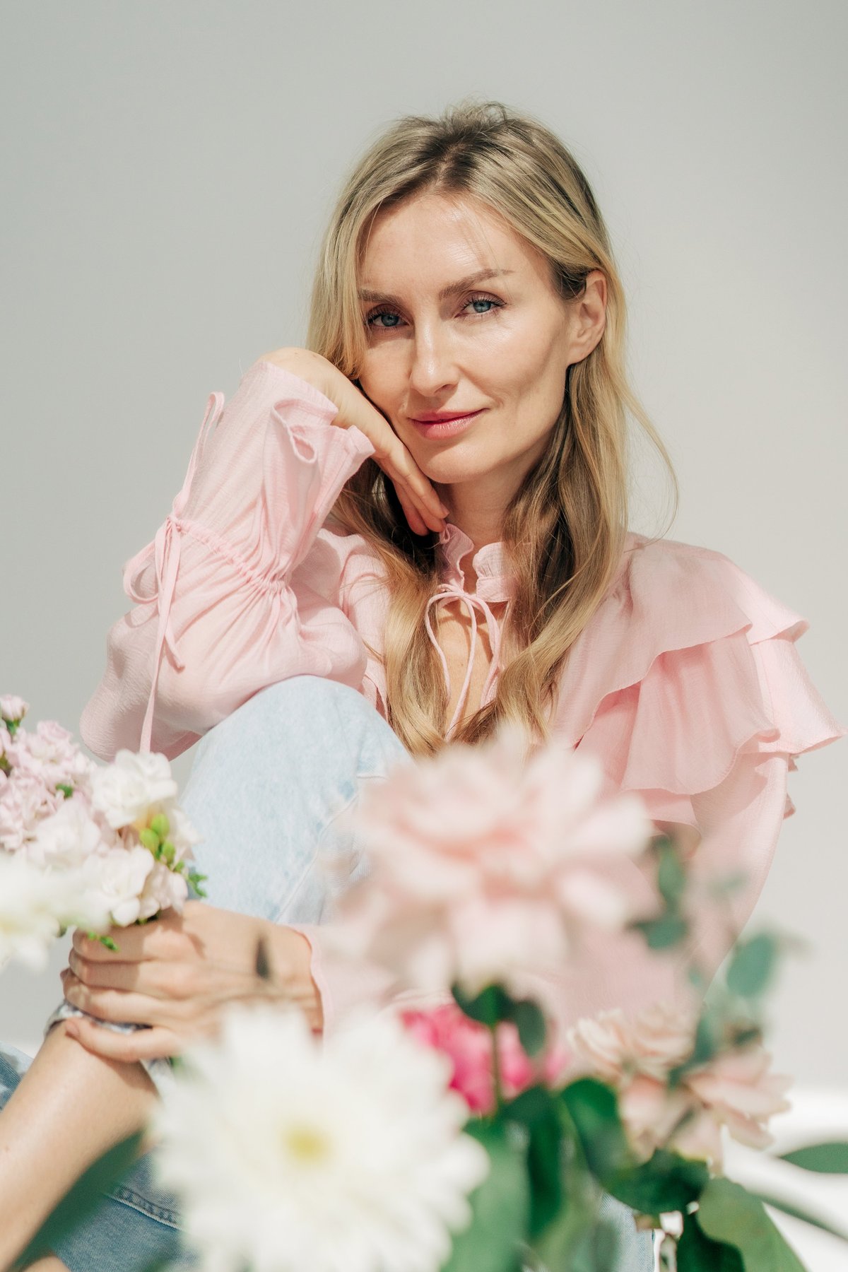 Portrait of an attractive woman with long hair with fresh spring flowers.
