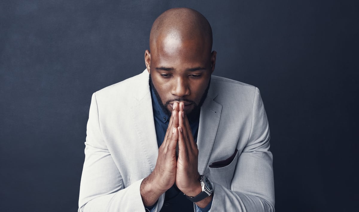 Studio shot of a businessman looking worried against a gray background
